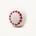 White crochet-style baseball dog toy with red stitching, on an ivory background; approximately 8 cm.